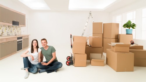 Office furniture and boxes prepared for a commercial move in Notting Hill